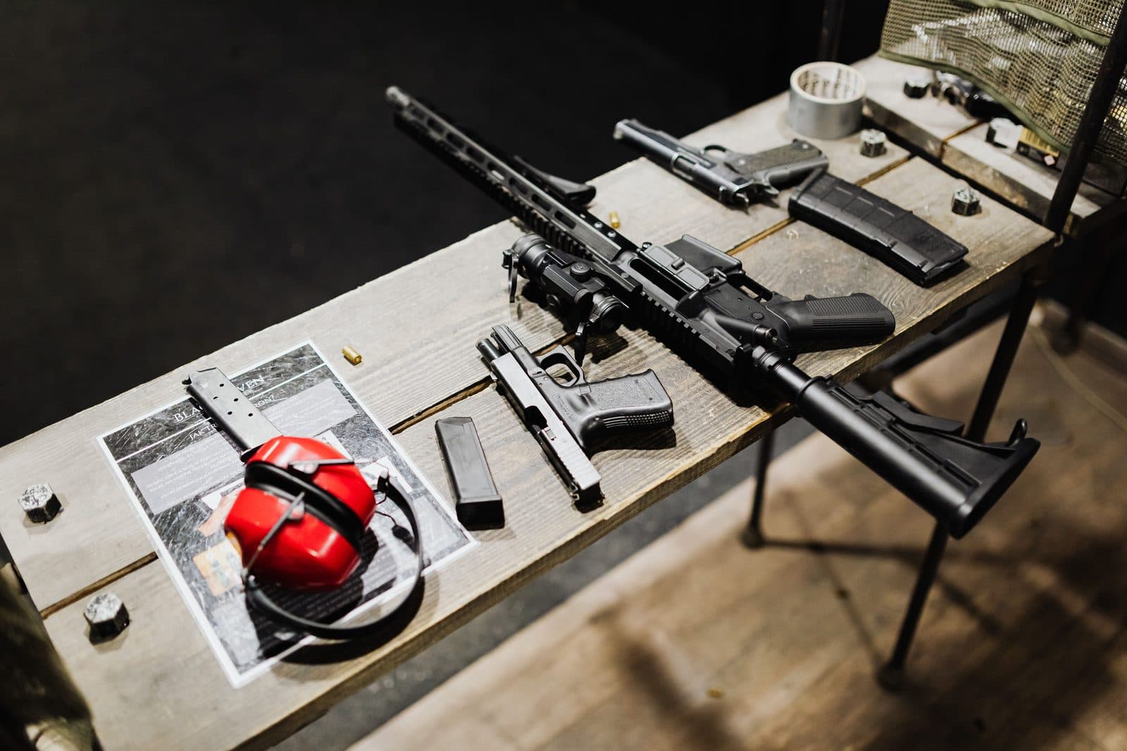 Shooter at an indoor range with a scoped rifle